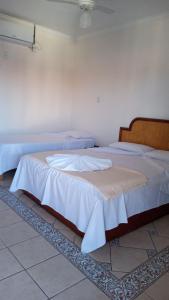 Giường trong phòng chung tại Pousada 4 Estações