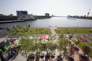 a view of a park next to a river at Hotel New York by WestCord in Rotterdam