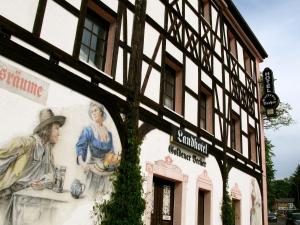 a building with a mural on the side of it at Landhotel Goldener Becher in Limbach - Oberfrohna