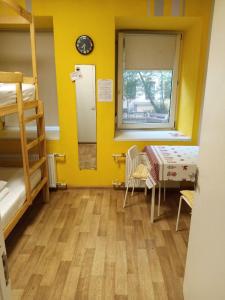 a room with bunk beds and a table and a window at Гостевой Дом "Bravo" на Казанской in Saint Petersburg