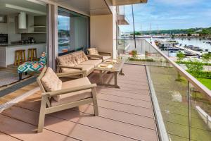 einen Balkon mit Gartenmöbeln und Blick auf den Yachthafen in der Unterkunft Yacht Park Marina by AmberBlue in Gdynia