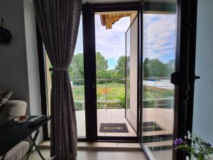 an open glass door with a view of a balcony at Camera la vila in Constanţa