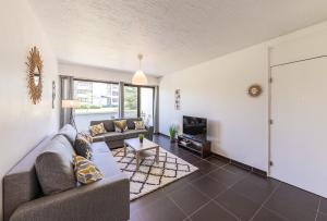 a living room with a couch and a table at Aux portes de Bordeaux Le Compostelle MindUrGuest in Pessac