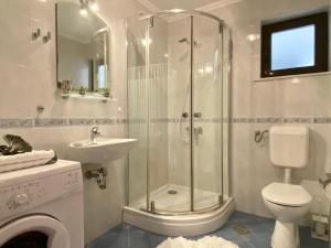 a bathroom with a shower and a toilet and a sink at Apartments La Perla in Mlini