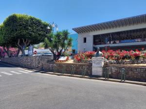 a statue in front of a building with flowers at Diamante in Sorrento