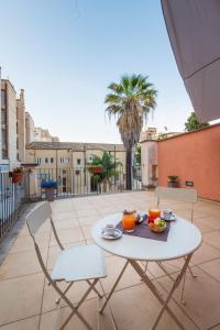 a white table and chairs on a patio with a view at Hotel Vittorio Veneto in Ragusa