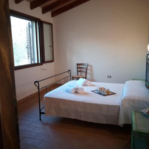 a bedroom with two beds and a window at Agriturismo Funtan'Arva in Loculi