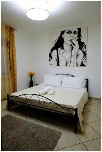 a bedroom with a bed with a poster of a woman at Beb Alla Marina Tortora in Tortora