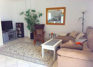 a living room with a couch and a table at Bahia El Calon in San Juan de los Terreros