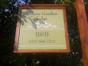 a sign for a manor garden lodge at Manor Garden Lodge in Wirral