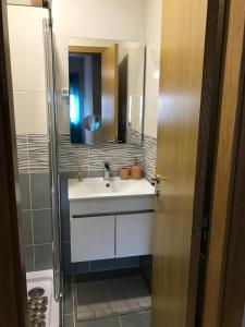 a bathroom with a sink and a mirror at Viriato Central House in Viseu