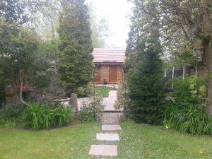 a garden with a walkway leading to a house at Manor Garden Lodge in Wirral