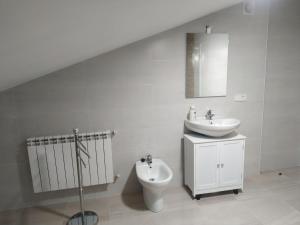 biała łazienka z umywalką i toaletą w obiekcie Edificio Valles del Lúpulo (DUPLEX) w mieście Astorga +28 zdjęć