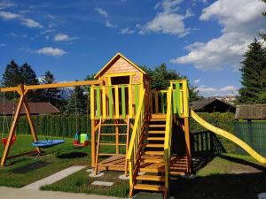 a playground with a slide and a play structure at Apartments and Wellness Jelovca in Radovljica