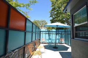 a balcony with a table and chairs and an umbrella at Venice Beach Apartments Monthly rents in Los Angeles