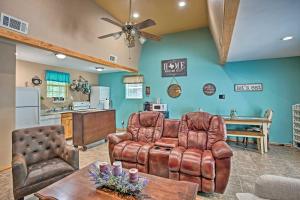 a living room with two leather chairs and a table at Lake Texoma Cabin - 1 Mi to Park and Boat Ramp! in Willow Spring