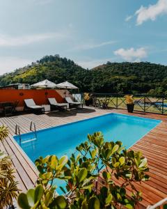 a swimming pool on top of a wooden deck at Kastel Itaipava in Itaipava