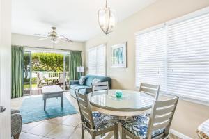 a living room with a glass table and chairs at Duck Key Retreat Villa #5105 in Duck Key