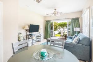 a living room with a table and a couch at Duck Key Retreat Villa #5105 in Duck Key