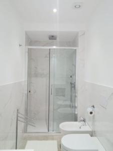 a bathroom with a shower and a toilet and a sink at Loris House in Tropea