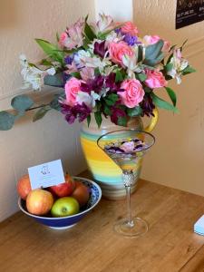 a vase with a bouquet of flowers and a bowl of fruit at Gyves House in Eastbourne