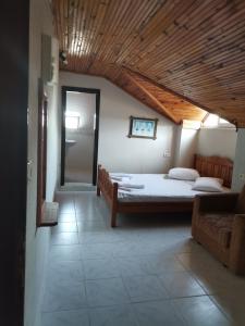 a bedroom with two beds and a wooden ceiling at Sirius star otel in Ortaca