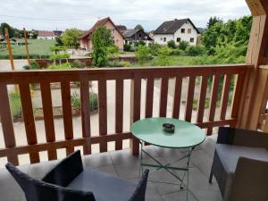 a balcony with a table and chairs and a view at Le Dormeur in Dorlisheim