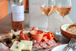a table with a plate of food and glasses of wine at Woolmarket House in Chipping Campden