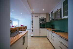 a kitchen with white appliances and wooden counter tops at Villa on Stone in Velika Cista