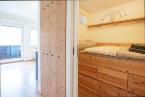 a bedroom with a bed and a wooden closet at Grenzberg - Bad Gastein in Bad Gastein