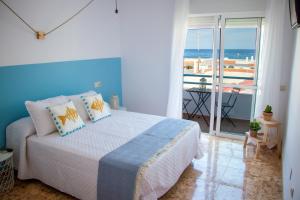 Postel nebo postele na pokoji v ubytování H El Palmeral Playa
