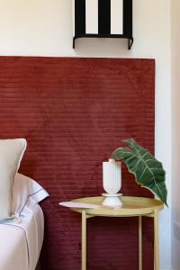 a table with a lamp on it next to a bed at Villa delle Palme in Santa Marinella