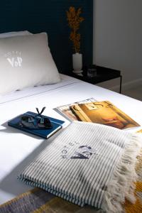 a bed with a mouse and a book on it at Villa delle Palme in Santa Marinella
