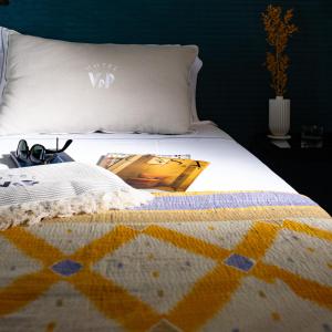 a bed with a quilt with a picture of a boat on it at Villa delle Palme in Santa Marinella