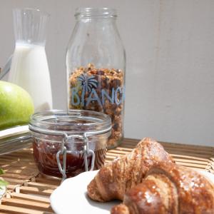 a table with a jar of bread and a plate of food at Villa delle Palme in Santa Marinella