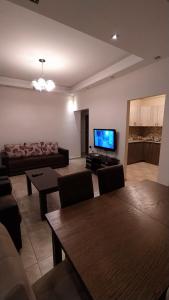 a living room with a couch and a flat screen tv at Elite Apartments in Yerevan