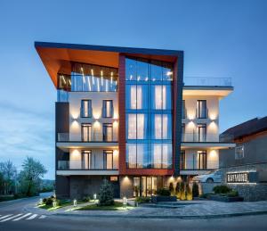 a rendering of a large building with lights on at Hotel Raymond in Truskavets