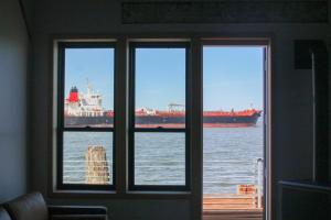 une fenêtre donnant sur un grand navire dans l'eau dans l'établissement Bowline Hotel, à Astoria