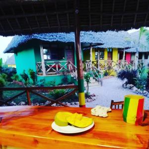 a table with yellow hats on top of a house at Kendwa Carletto Style in Kendwa