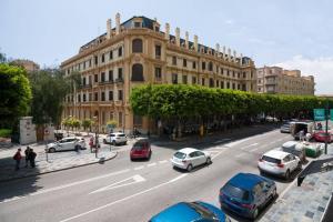 a busy city street with cars parked in front of a building at Miramar Luxury 2 bedroom FreshApartments in Málaga