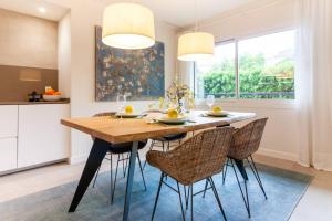 a dining room with a wooden table and chairs at Miramar Luxury 2 bedroom FreshApartments in Málaga