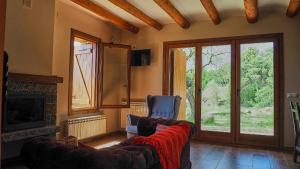 a living room with a couch and a fireplace at Casa rural EL PAJAR DE TEJEDOR in Mondot