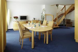 a dining room with a table and chairs at Apartment-Hotel Schaffenrath in Salzburg