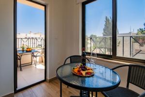 a table with a bowl of fruit on top of a balcony at Canary Boutique Hotel in Amman