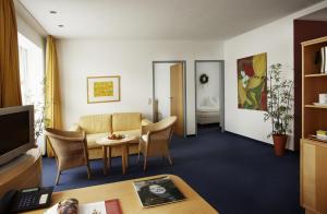 a living room with a couch and a table at Apartment-Hotel Schaffenrath in Salzburg