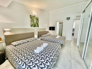 two beds in a small room with at Villa 12 in Adeje