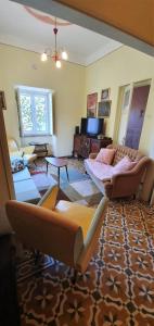 a living room with two couches and a tv at Villa Rosa Boutique in Almancil
