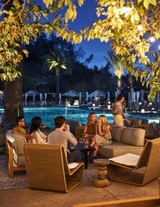 a group of people sitting in chairs by a pool at Solage, Auberge Resorts Collection in Calistoga