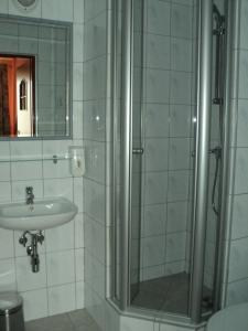 a bathroom with a shower and a sink at Hotel Primagor in Szydłowiec