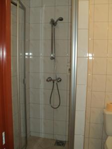 a shower with a shower head in a bathroom at Hotel Primagor in Szydłowiec +21 photos